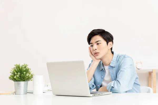 Bored Young Handsome Asian Using Laptop — Stok fotoğraf