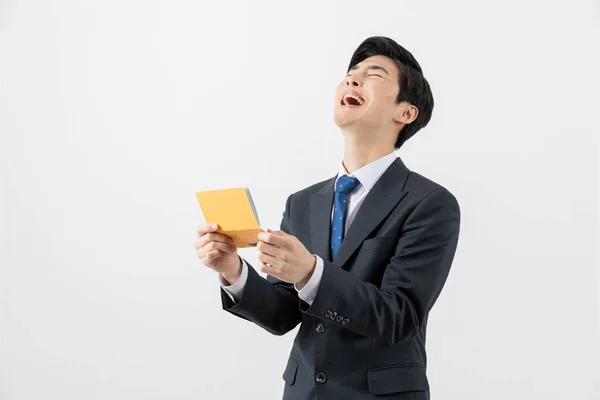 Happy Asian Man Checking His Balance Bank Book — Stock Fotó