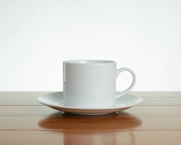 Empty white mug with saucer on wood — Stock Photo, Image