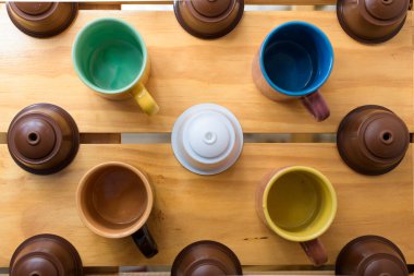 Farklı renkte kahve fincanları ve espresso kapsülünün hava manzarası.