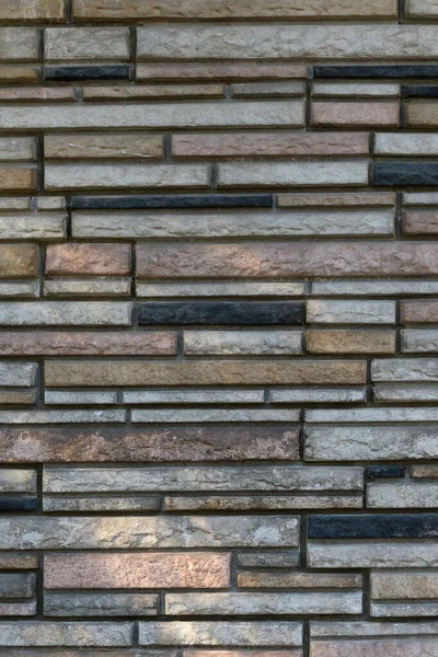 異なる形状と色の長方形の石の壁 — ストック写真