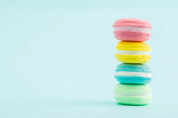 French colorful macarons stacks on pastel background, retro Styl