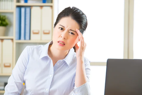 Young asian business woman with headache Royalty Free Stock Images