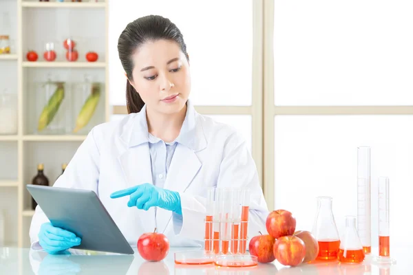 Asian female scientist touch the digital tablet to research — Stock Photo, Image