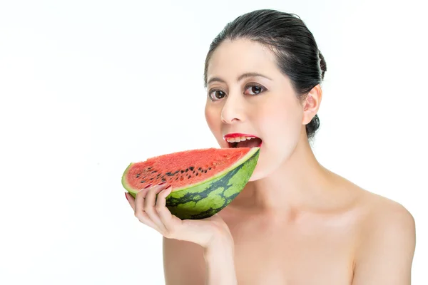 Fashion woman enjoy eating armelon with red lips, yummy, bite — стоковое фото