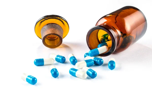 Blauwe capsules met fles, gezondheidszorg en medicijnen — Stockfoto