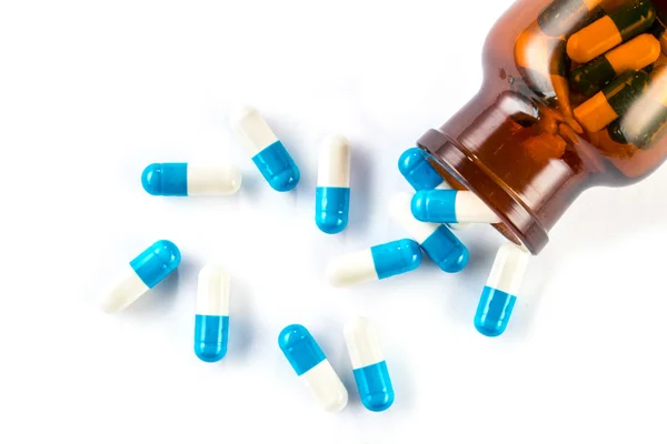 Cápsulas azules con frasco, cuidado de la salud y medicamentos —  Fotos de Stock