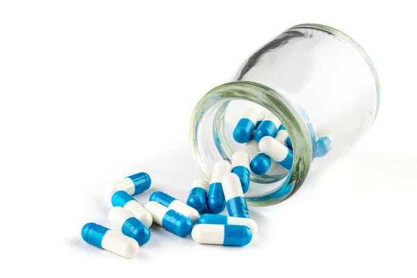 Cápsulas azules con Frasco transparente, cuidado de la salud y medicamentos —  Fotos de Stock
