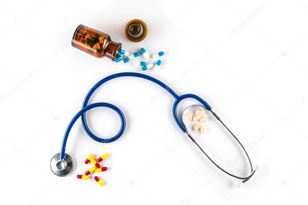 capsule in bottle with Stethoscope and pill cardiology