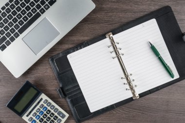 defter ve kalem masanın üzerinde hesap makinesi ile