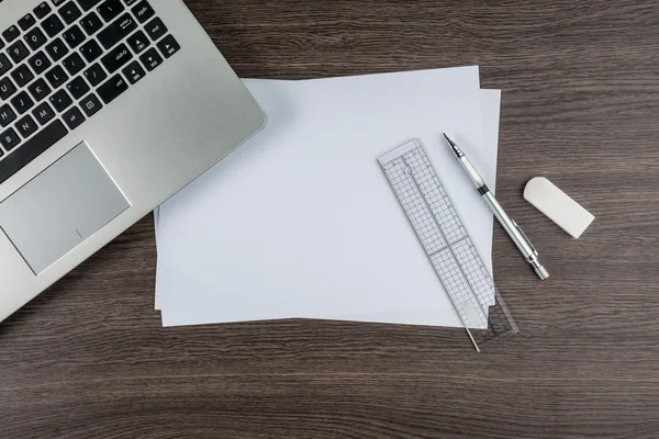 Laptop, paper pen Ruler and Eraser on work desk — Stock Photo, Image