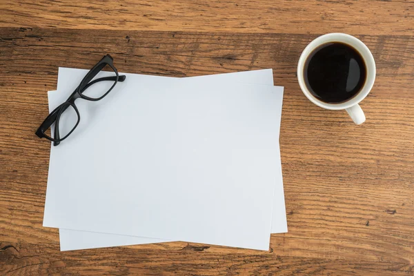 Paper and glasses with cup of coffe office — Stock Photo, Image