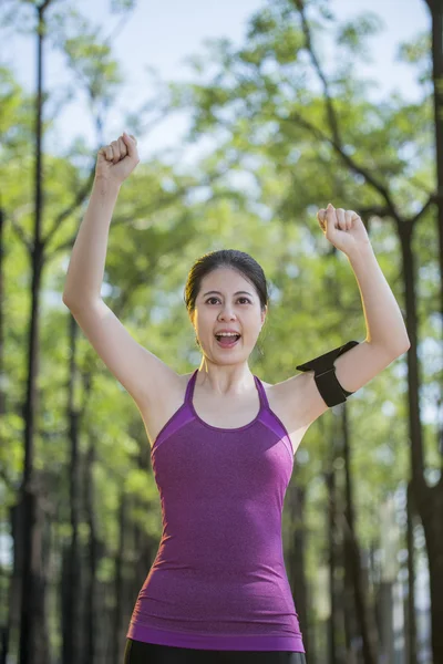 Sporty asian woman with arms up celebrating success — Stock Photo, Image