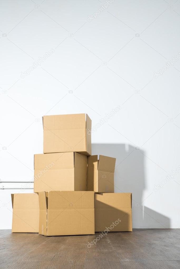 Pile of cardboard boxes on white background with box shadow