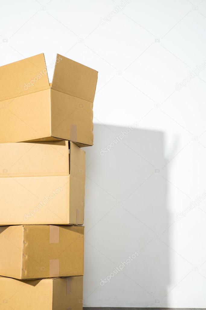 Pile of cardboard boxes on white background with box shadow