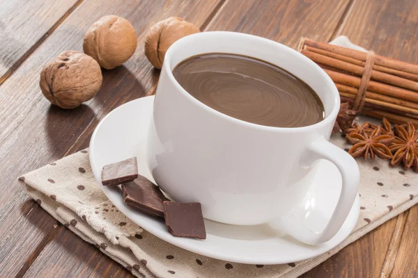 Mug filled with homemade hot chocolate, spice with walnut Stock Picture