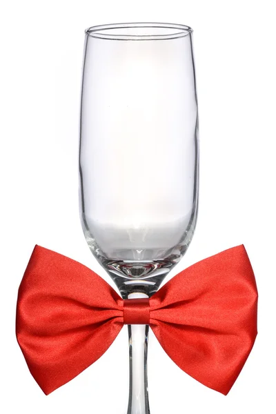 Bicchiere di champagne vuoto con papillon rosso — Foto Stock