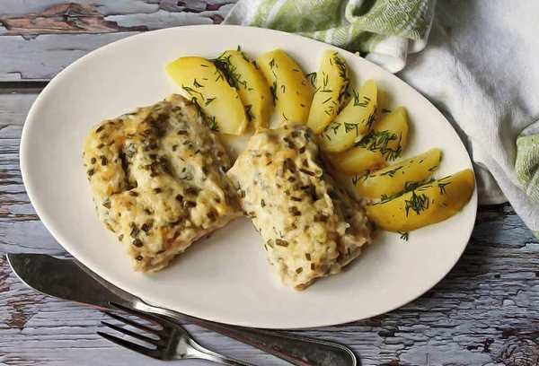 Hoki - delicious, sea fish from the order of cod has a different name - grenadier. Baked fish in the oven under cheese in foil turns out to be very tender, elastic and no doubt everyone will like it. Enjoy your meal!