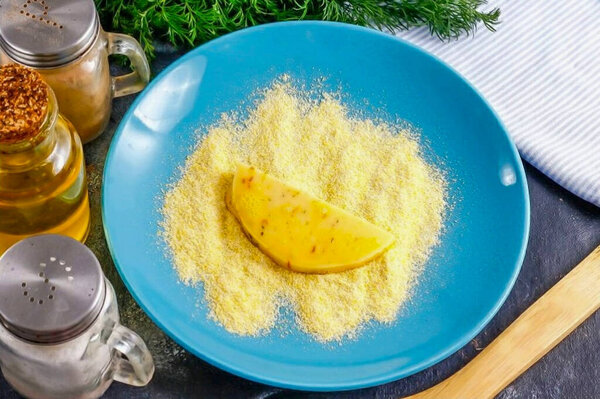 Окуните сыр в измельченные хлебные крошки или кукурузную муку, и немедленно поместите в горячее масло.