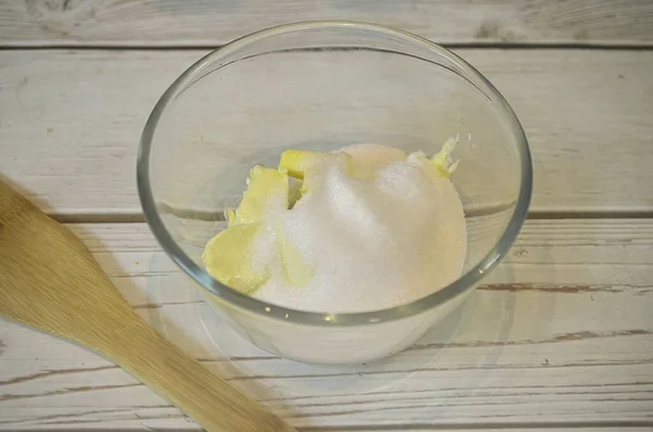 Add sugar and vanilla sugar to butter at room temperature.