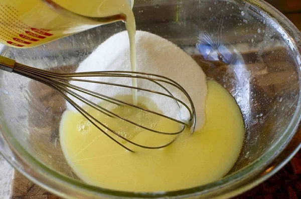 溶かしたバターをボウルにレモンゼスト レモン汁を加え 泡立て器でよく混ぜます — ストック写真