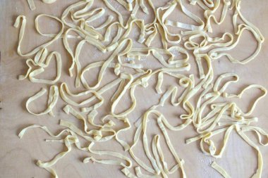 Spread the noodles on a board and dry for 15 minutes, then you can boil them. Boil the noodles in boiling salted water for 10 minutes. If you want to prepare the noodles for future use, leave them for a day. Flip the noodles several times throughout  clipart