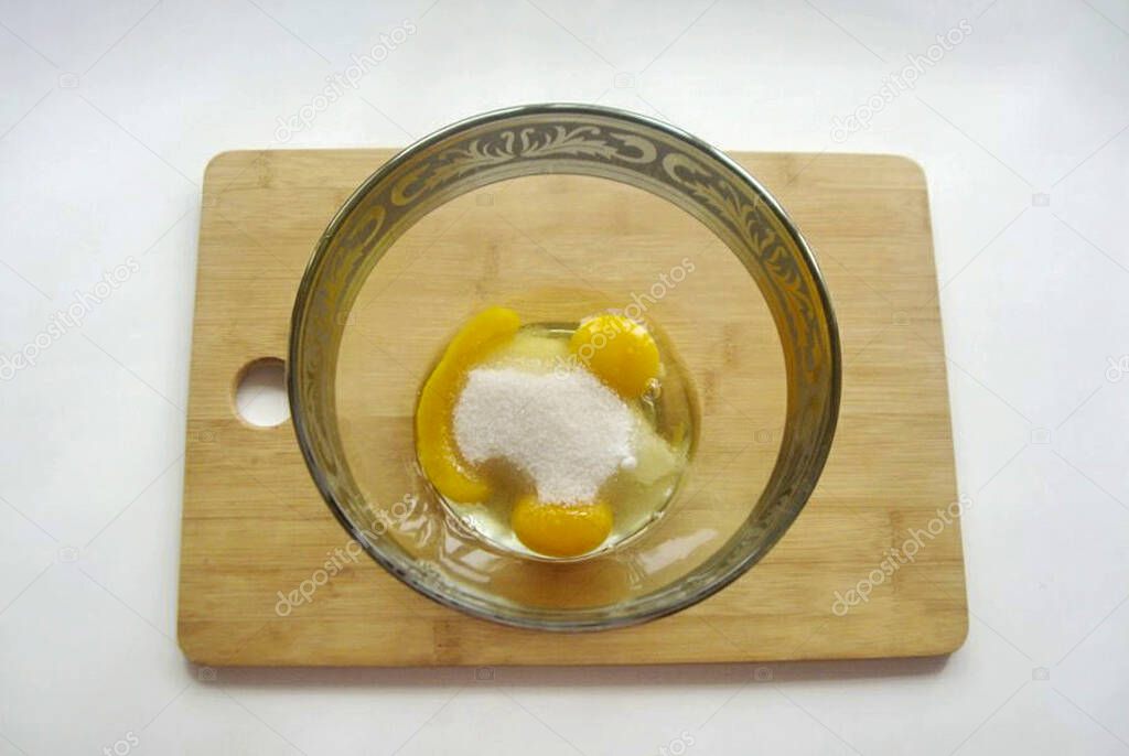 Pour the remaining sugar into a bowl over the yolks.