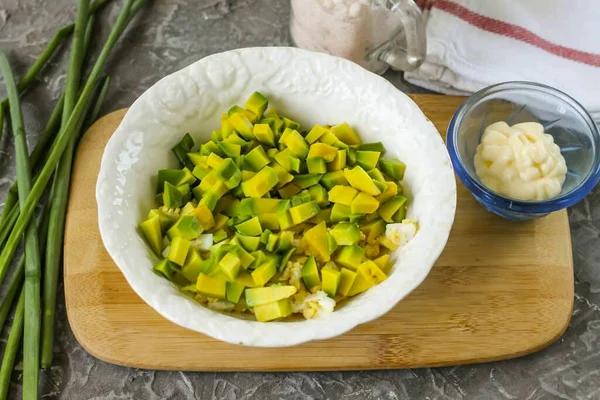 Peel half of the avocado, remove the kernel. Cut the pulp into small cubes. If you will not season the pate with mayonnaise, then replace it with lemon juice, otherwise the avocado slices will darken.