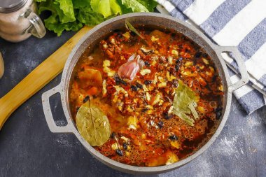 Pour boiling water over and cover the container with a lid. Cook on moderate heat for about 45 minutes until the liquid evaporates completely.