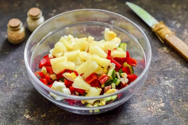 Cut canned pineapples into small cubes and add to salad.