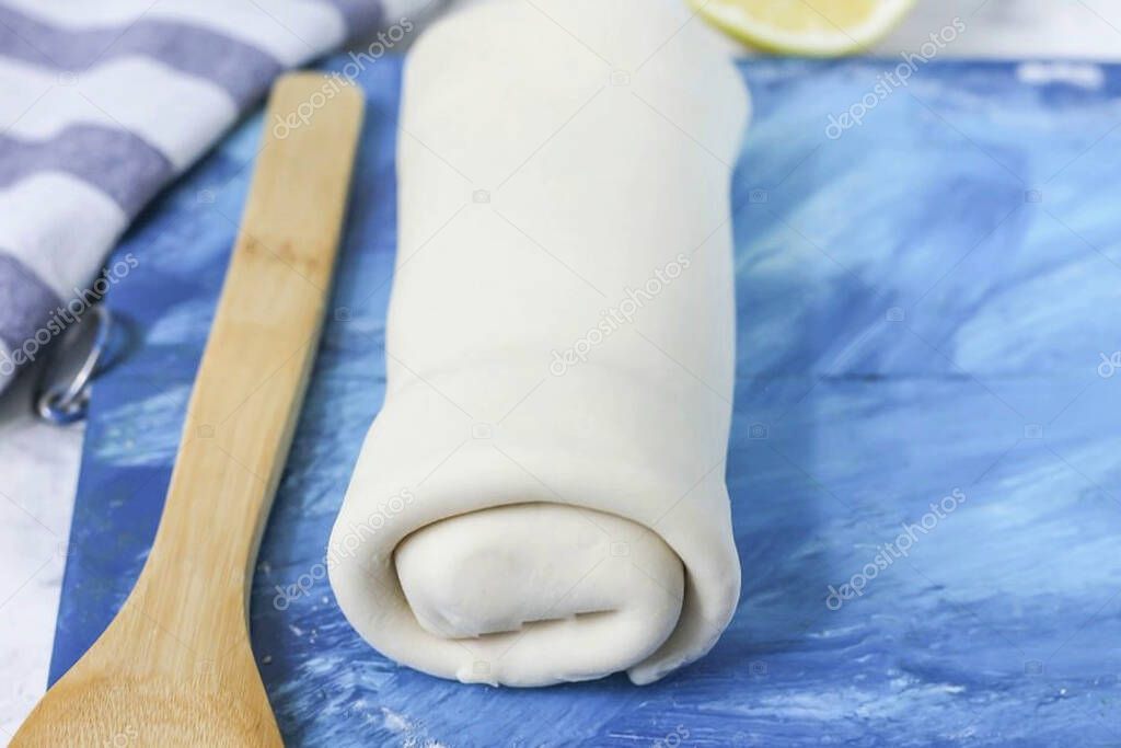 Then roll the filled dough into a roll and place it on parchment paper, covering a baking sheet with it. Preheat oven to 200 degrees and bake strudel for 30 minutes.