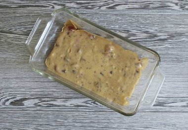 Grease a rectangular baking dish with a thin layer of butter or cover with baking paper. Pour the dough and flatten. Put to bake in an oven preheated to 180 degrees for 30-35 minutes.