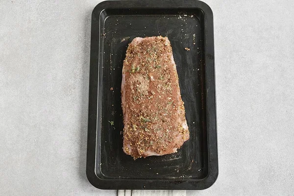 Dry a piece of carbonate with a napkin and grease liberally with mustard. I prefer cereal, but that\'s a matter of taste. Sprinkle the spice mixture on top, pressing it against the meat to form a dense layer. You can do this directly on a baking sheet