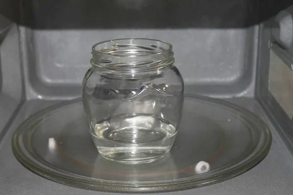 Wash the jars thoroughly in hot water along with baking soda and pour 1 centimeter high of water into them. Place in the microwave, turn on full power for 4 minutes to sterilize. Boil the lids on the stove for 10 minutes.