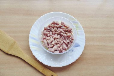 Haşlanmış domuzu küçük küplere ayır ve ikinci tabaka salatayla birlikte uzan. Mayonez uygula.