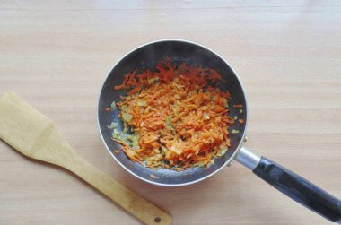 Havuç ve soğan soy ve yıka. Havuçları rendele ve soğanı ince ince doğra. Tavanın içine koy. Düşük ısıya karşı yumuşak olana kadar sebze yağı ve saut sebzesi ekle