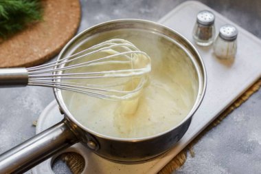 Stir vigorously with a whisk until the cheese dissolves. clipart