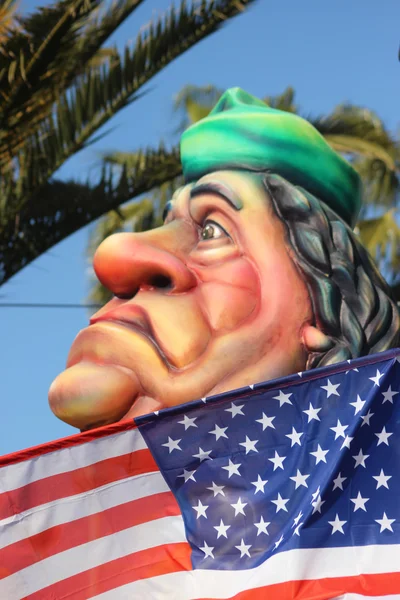 Muammar Gaddafi behind the American Flag — Stock Photo, Image