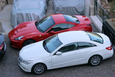 Luxury Cars Parked in a Parking Lot clipart