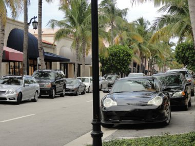 Very expensive luxury cars parked on a street in Palm Beach, Flo clipart