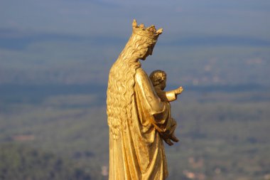 Golden statue of Virgin Mary and Baby Jesus clipart