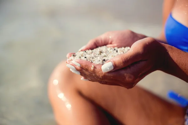 Girls hands holding unusual sand at the sea — Stock Photo, Image
