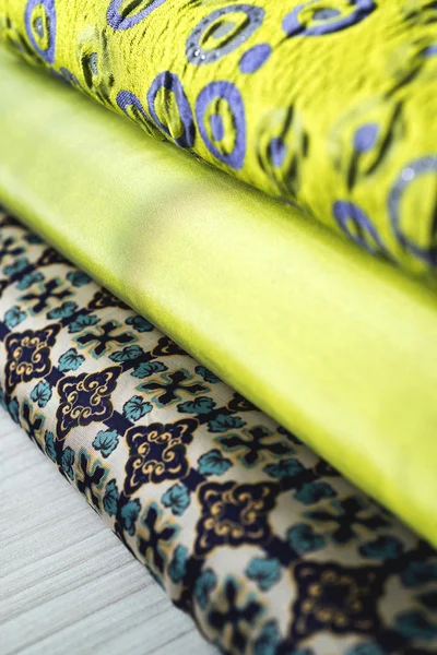 Rolls of colorful fabric as a vibrant background image — Stock Photo, Image