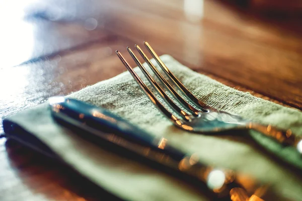 Knife and fork set on a wooden vintage table. Selective Focus — Stock Photo, Image