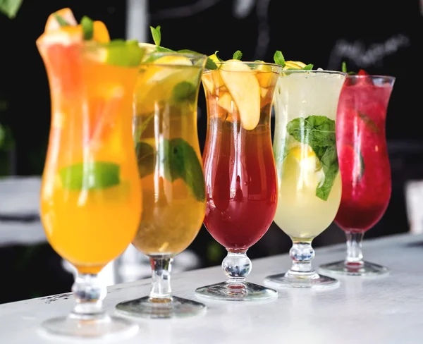 Refreshing cocktails with lime, mint, orange and strawberry — Stock Photo, Image