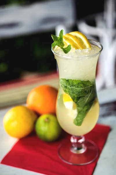 Fresh green lime soft lemonade in a glass on wooden table with decorations. Selective focus — Stock Photo, Image