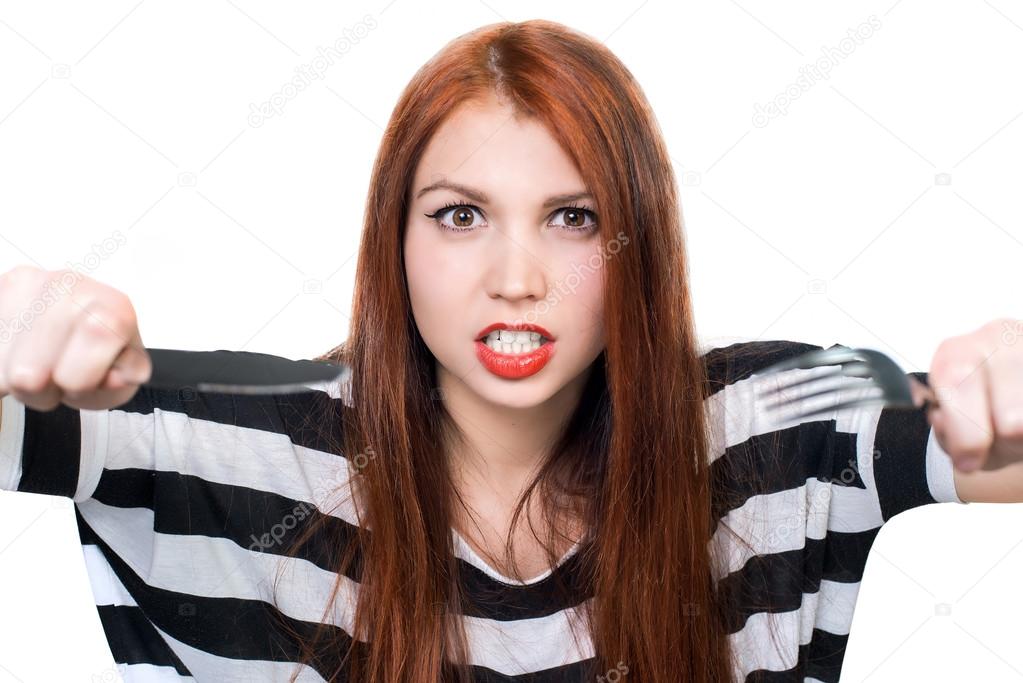portrait of shouting woman with fork and knife against white background