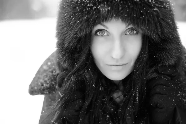 Young woman in a snowy furry hood — Stock Photo, Image