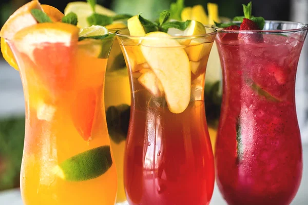 Refreshing cocktails with lime, mint, orange and strawberry — Stock Photo, Image