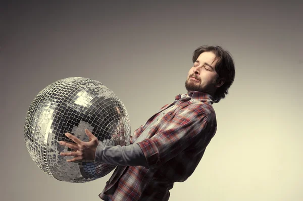 Young man posing with a disco ball — Stock Photo, Image